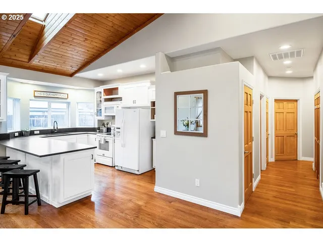 a open kitchen with stainless steel appliances granite countertop a refrigerator and a sink