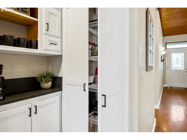 a kitchen with a refrigerator and cabinets