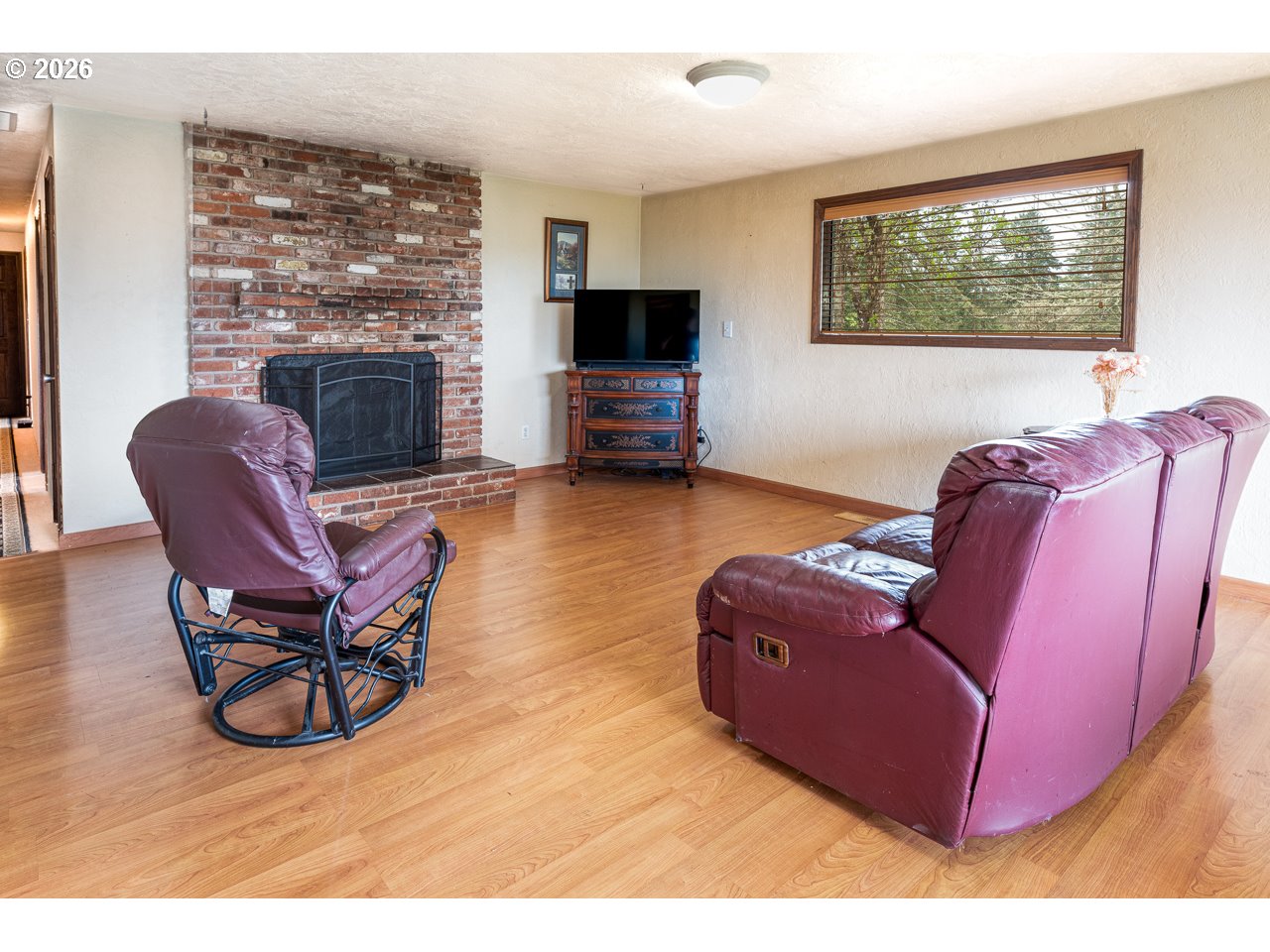 31514 Berlin Road Lebanon, OR 97355 - Photo 20 of 47 a living room with furniture a flat screen tv and a fireplace
