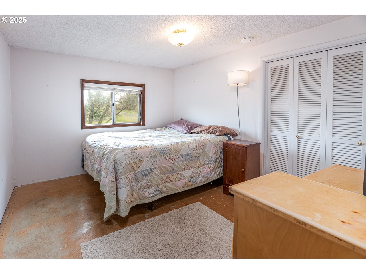 31514 Berlin Road Lebanon, OR 97355 - Photo 27 of 47 a bedroom with a bed and a night stand