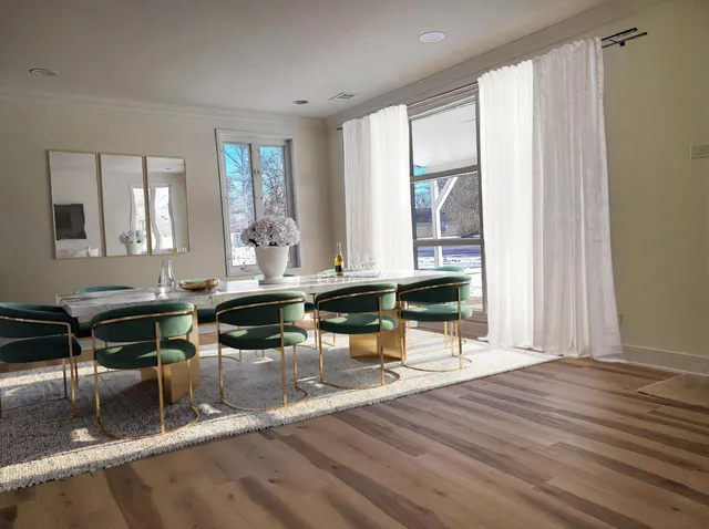 a living room filled with furniture hardwood floor and a large window