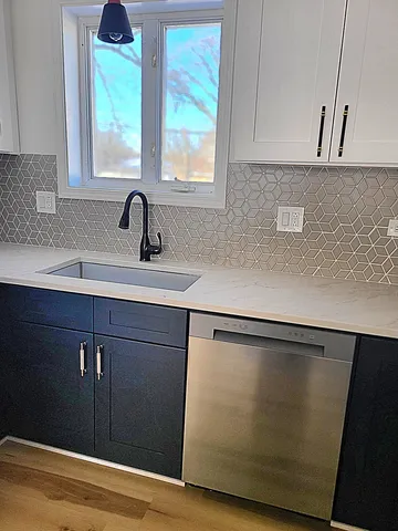 a kitchen with a sink and a window