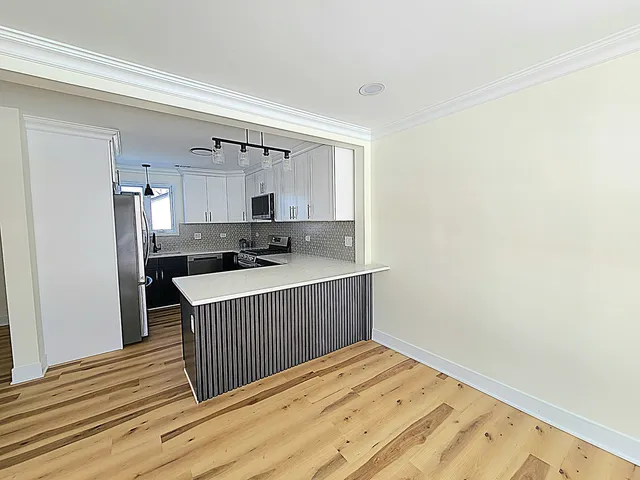 a view of kitchen with wooden floor