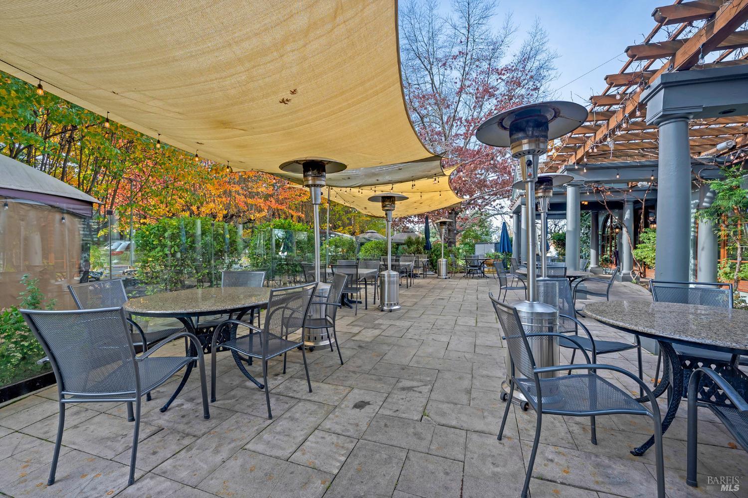 8050 Bodega Avenue Sebastopol, CA 95472 - Photo 15 of 45 a view of a patio with a table and chairs under an umbrella