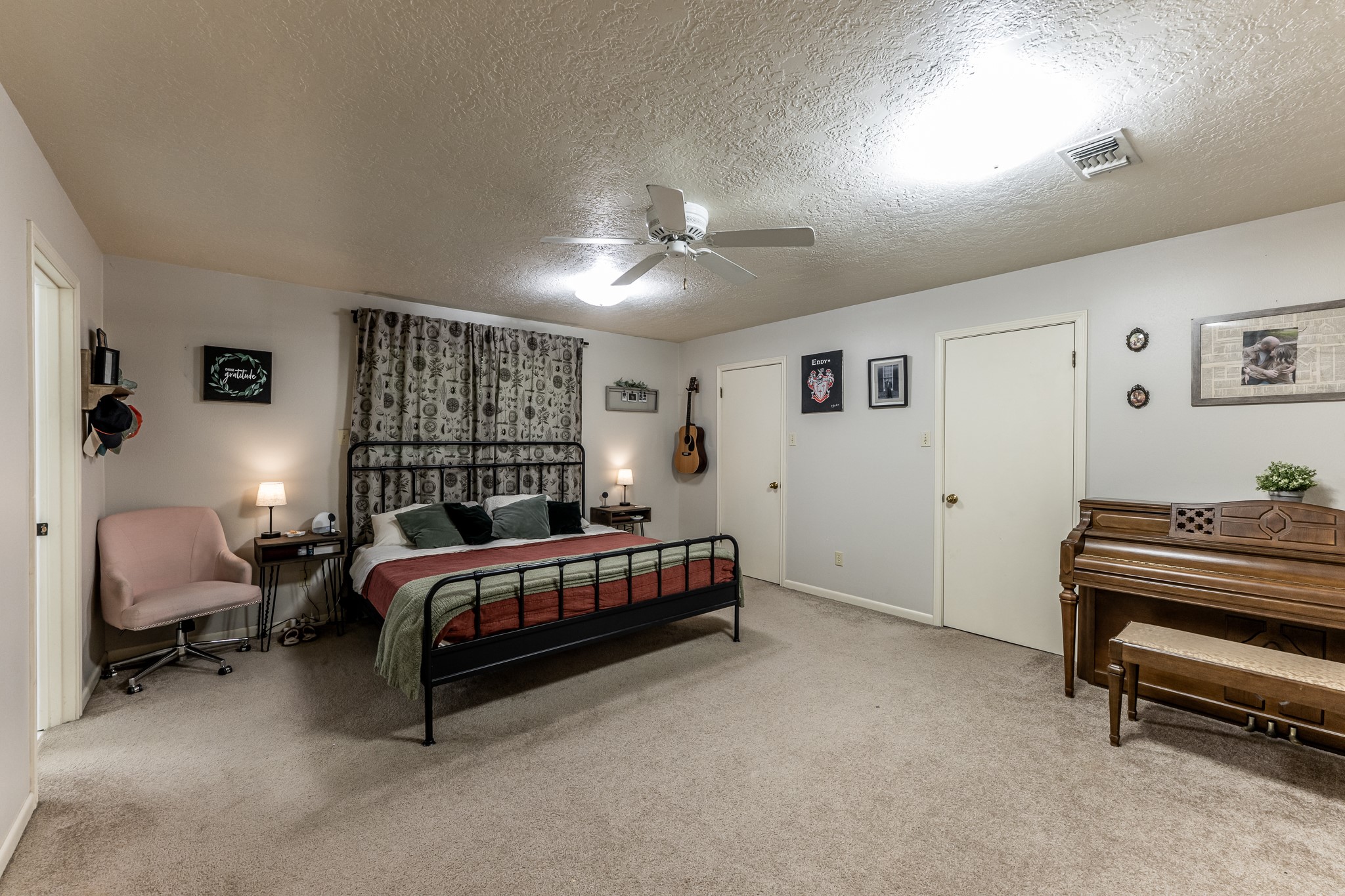 3304 Parr Drive Huntsville, TX 77320 - Photo 15 of 40 a bedroom with a bed and a chandelier