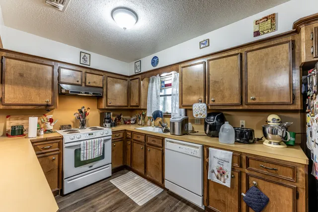 a kitchen with stainless steel appliances a sink stove and cabinets