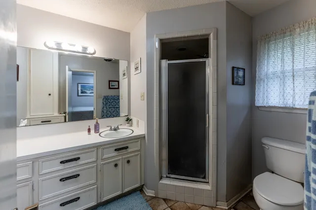a bathroom with a double vanity sink toilet and shower