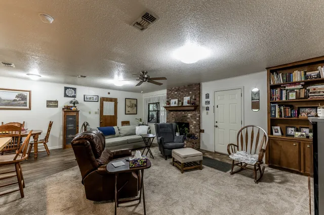 a living room with furniture and a piano