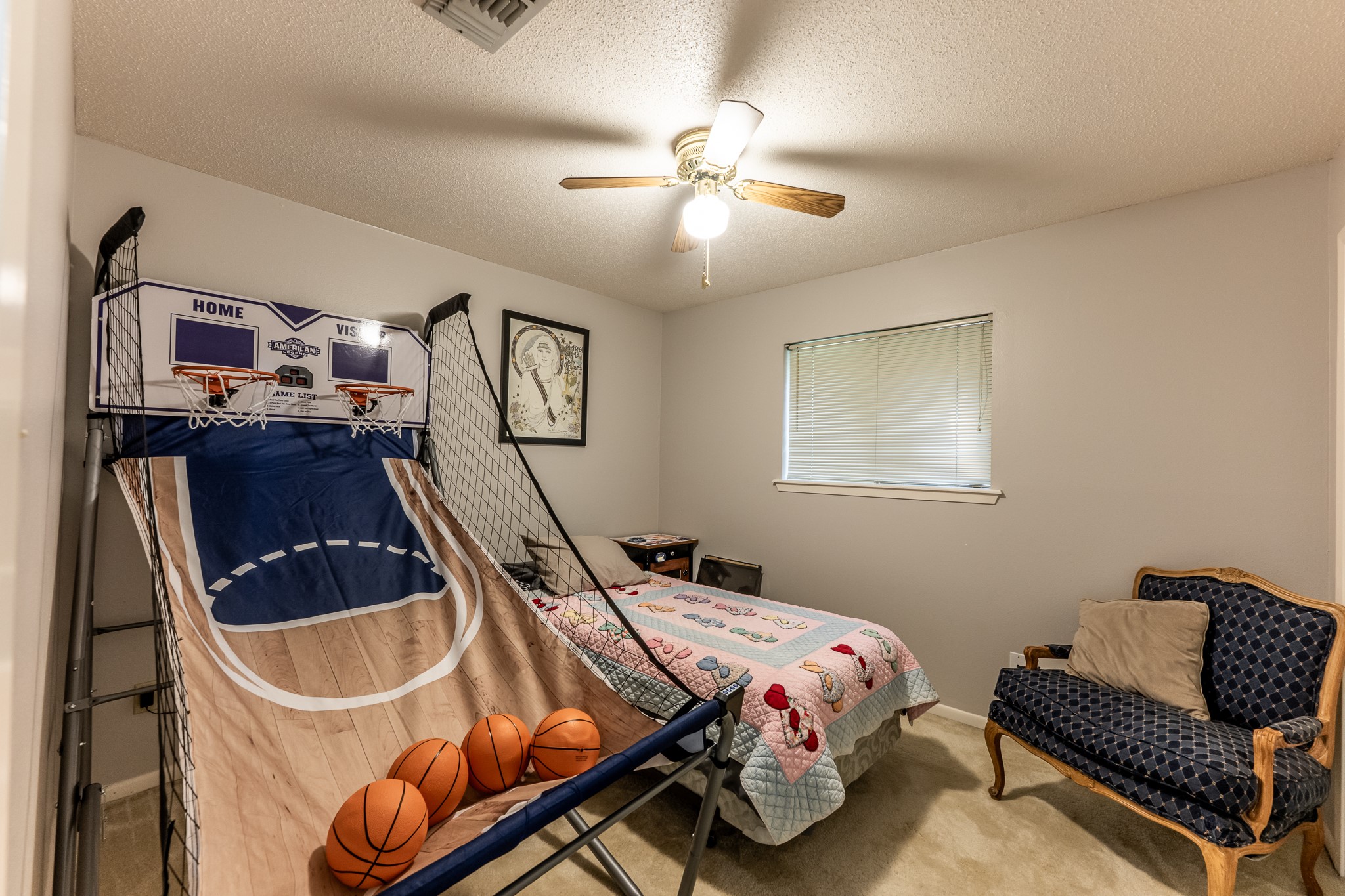 3304 Parr Drive Huntsville, TX 77320 - Photo 27 of 40 a bedroom with a bed and a chandelier