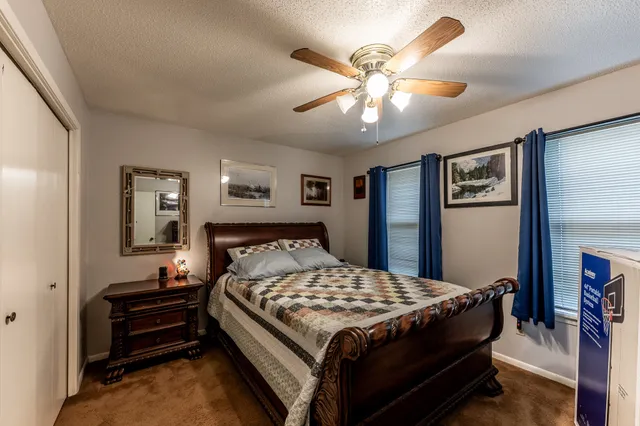 a bedroom with a bed and a chandelier