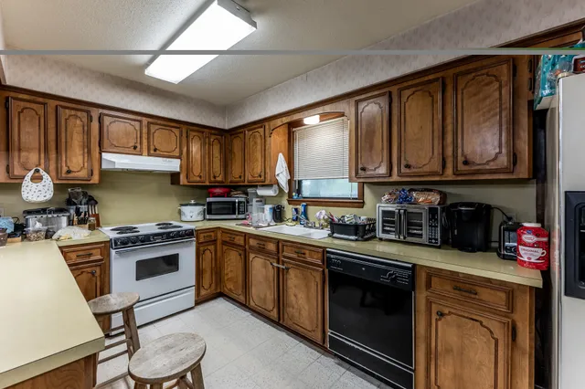 a kitchen with a sink cabinets and stainless steel appliances