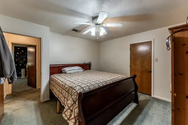 a bedroom with a bed and a chandelier