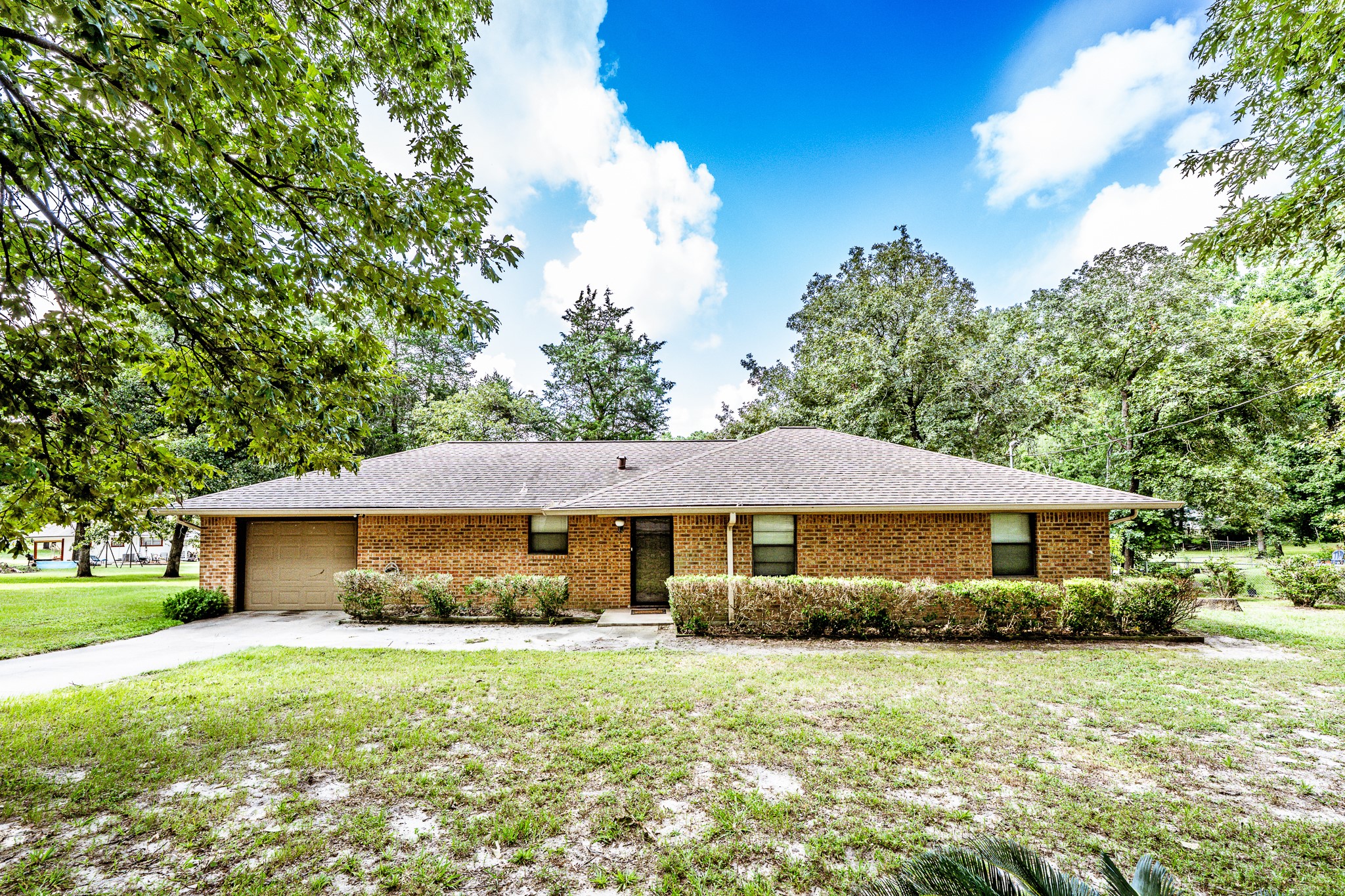 3304 Parr Drive Huntsville, TX 77320 - Photo 6 of 40 a front view of a house with a yard and trees