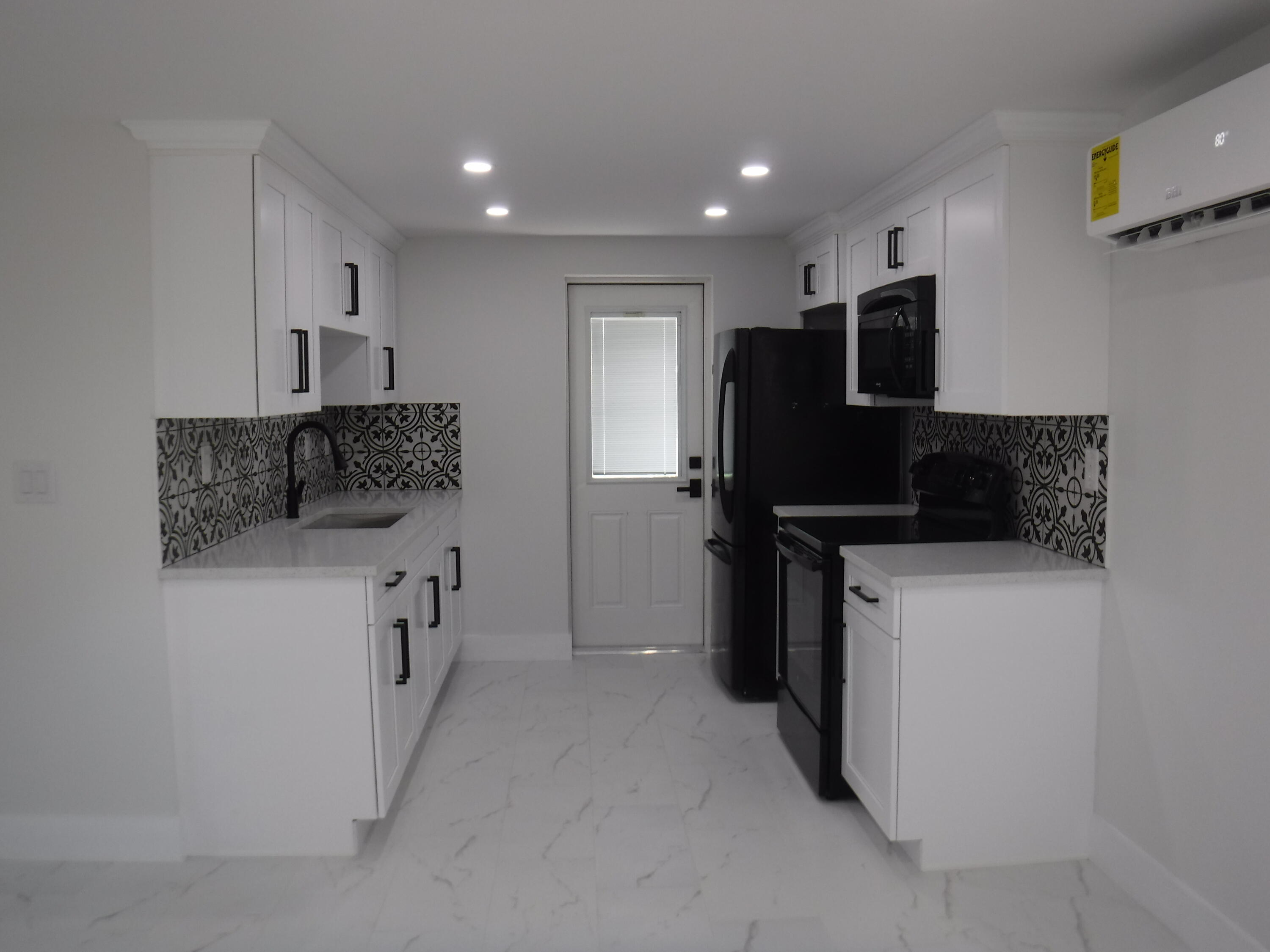1280 Sunset Road West Palm Beach, FL 33406 - Photo 3 of 24 a kitchen with a refrigerator and a stove top oven