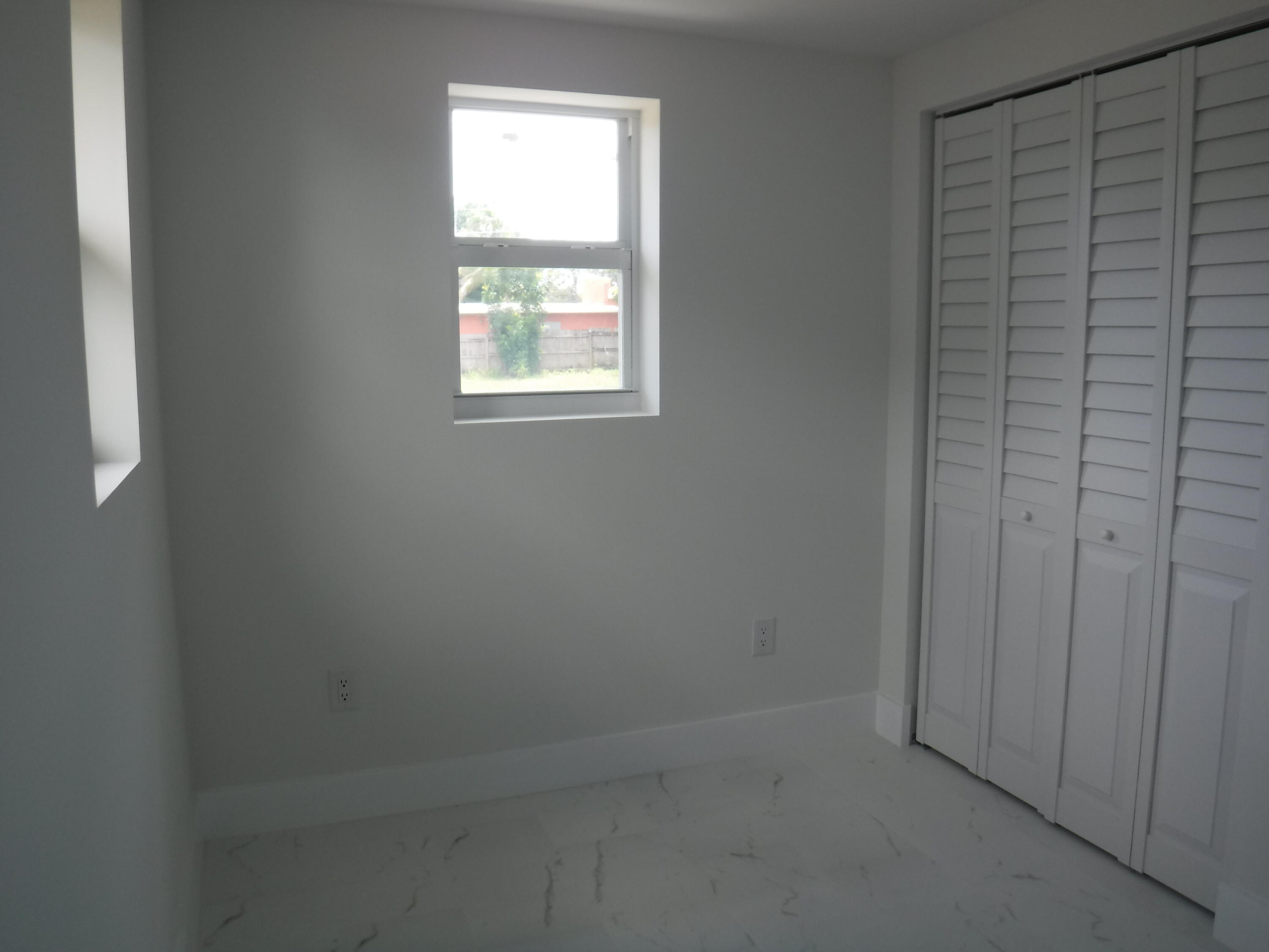 1280 Sunset Road West Palm Beach, FL 33406 - Photo 5 of 24 an empty room with windows