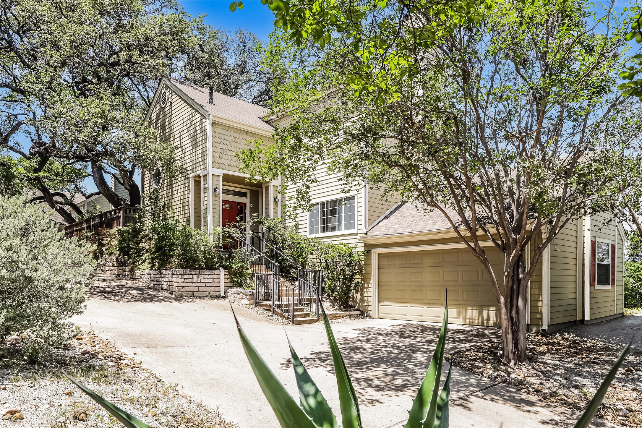 1702 Newning Avenue, Unit A Austin, TX 78704 - Photo 2 of 20 Two-story residence featuring light siding, a red front door, and an integrated garage