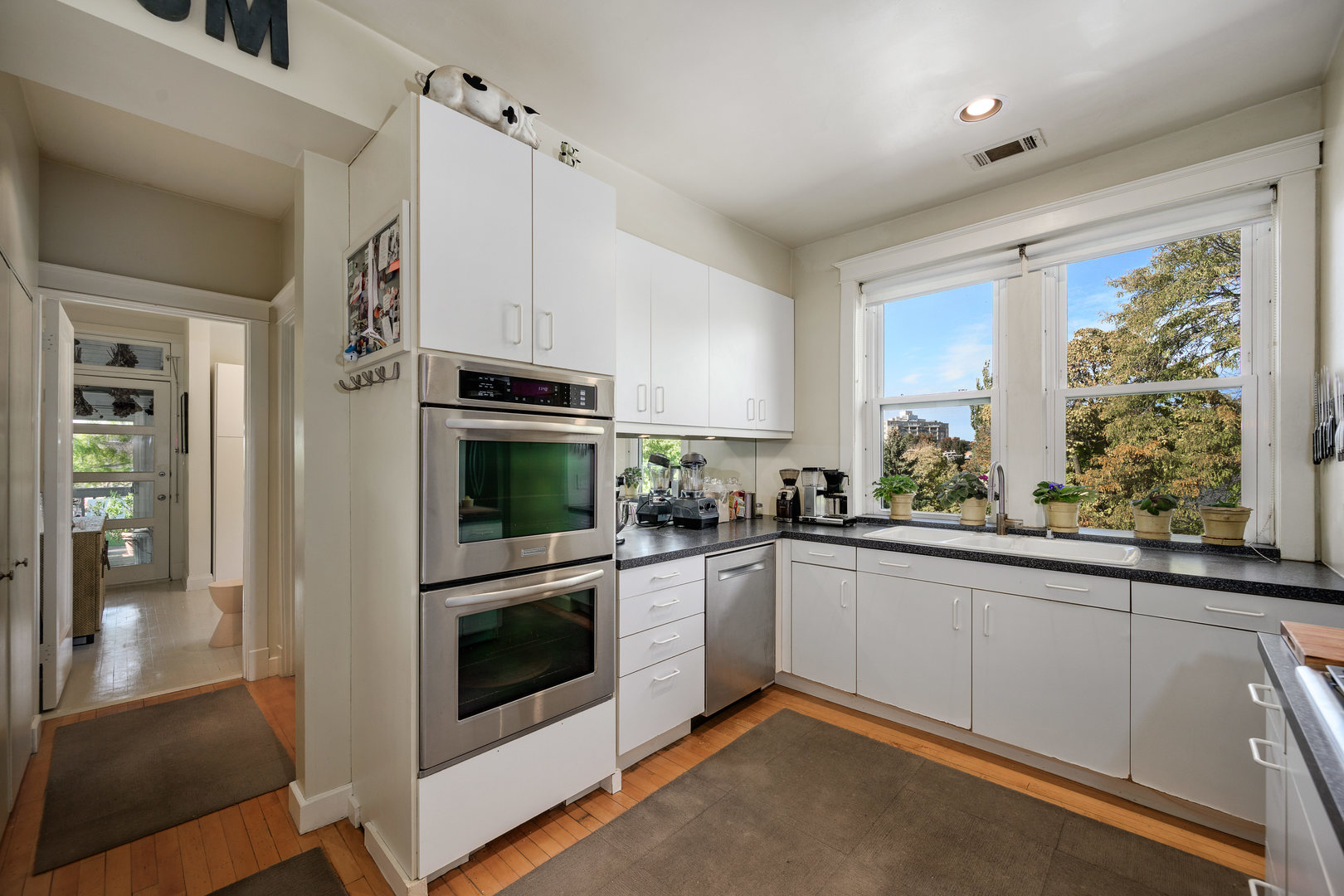 4224 North Hazel Street, Unit 3 Chicago, IL 60613 - Photo 23 of 33 a kitchen with granite countertop stainless steel appliances and white cabinets