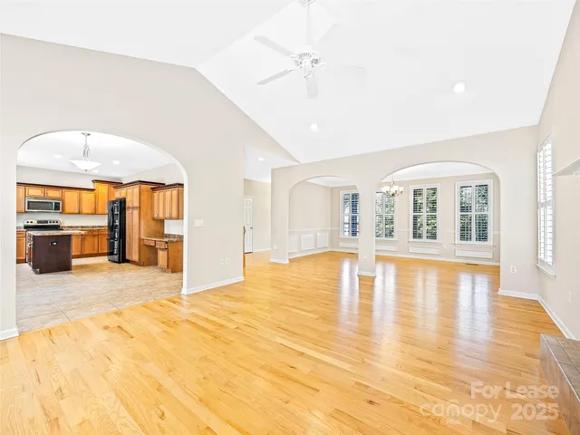 a big room with wooden floor and large windows