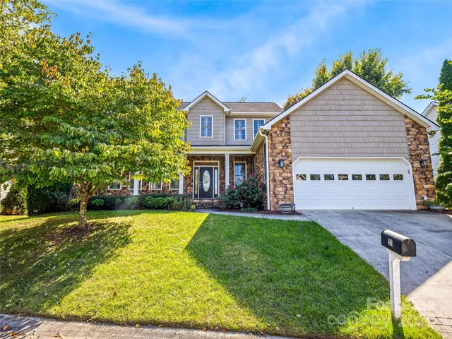 a view of a house with a yard patio and swimming pool
