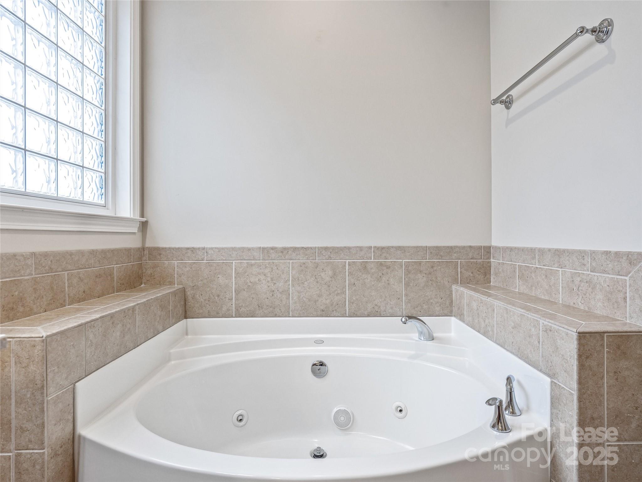 51 Driftstone Circle Arden, NC 28704 - Photo 27 of 38 a bathroom with bathtub and window