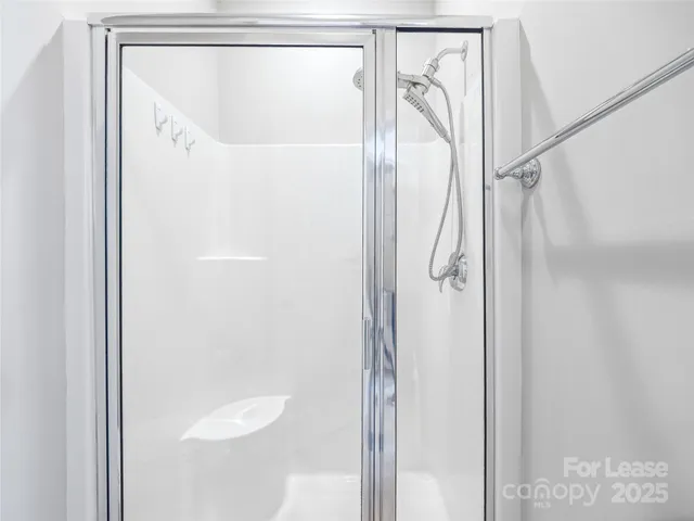 a bathroom with a glass shower door