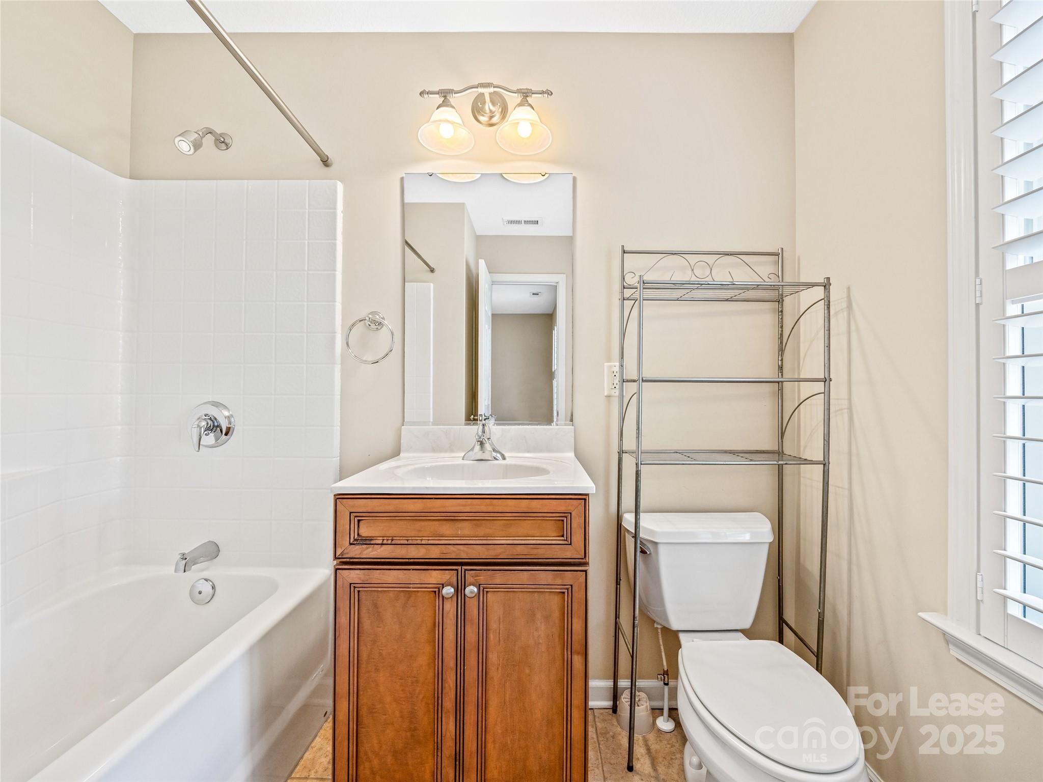 51 Driftstone Circle Arden, NC 28704 - Photo 36 of 38 a bathroom with a toilet sink vanity granite tub and shower