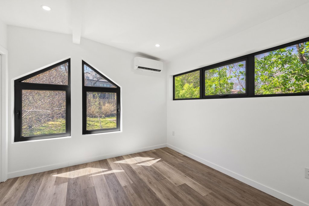 2503 Rockingham Drive Austin, TX 78704 - Photo 37 of 40 a view of an empty room with wooden floor and a window