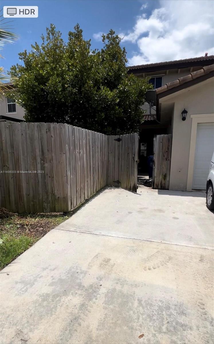 11665 Southwest 244 Street, Unit 116 Homestead, FL 33032 - Photo 4 of 32 a view of wooden fence