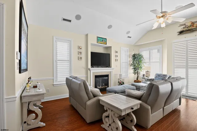 a living room with furniture a fireplace and a flat screen tv