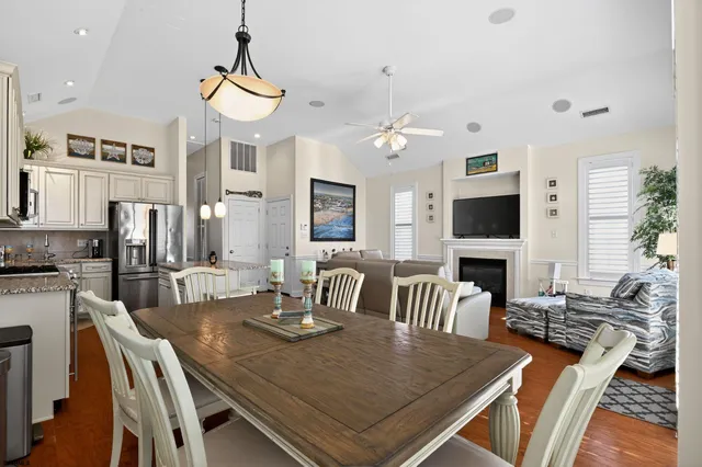 a view of a dining room with furniture a chandelier and wooden floor