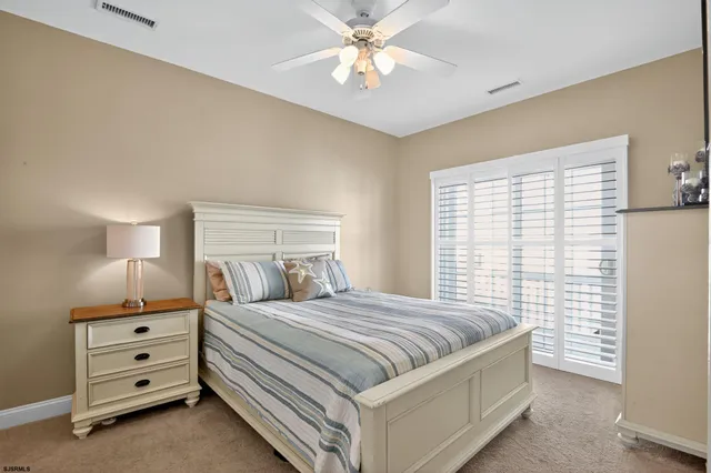 a bedroom with a bed and a night stand