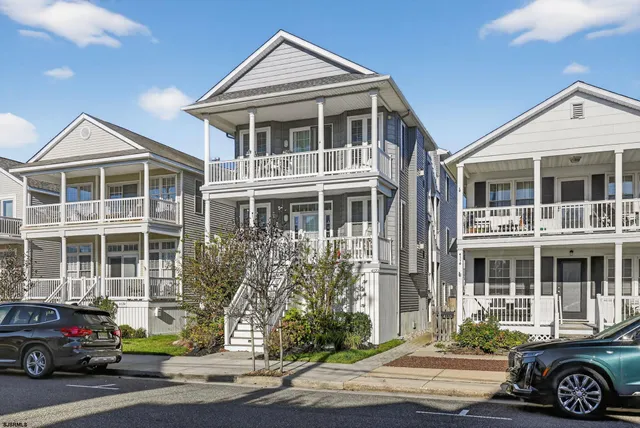 a front view of a residential apartment building with a yard