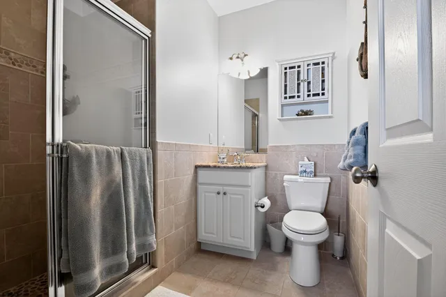 a white toilet sitting next to a bathroom sink