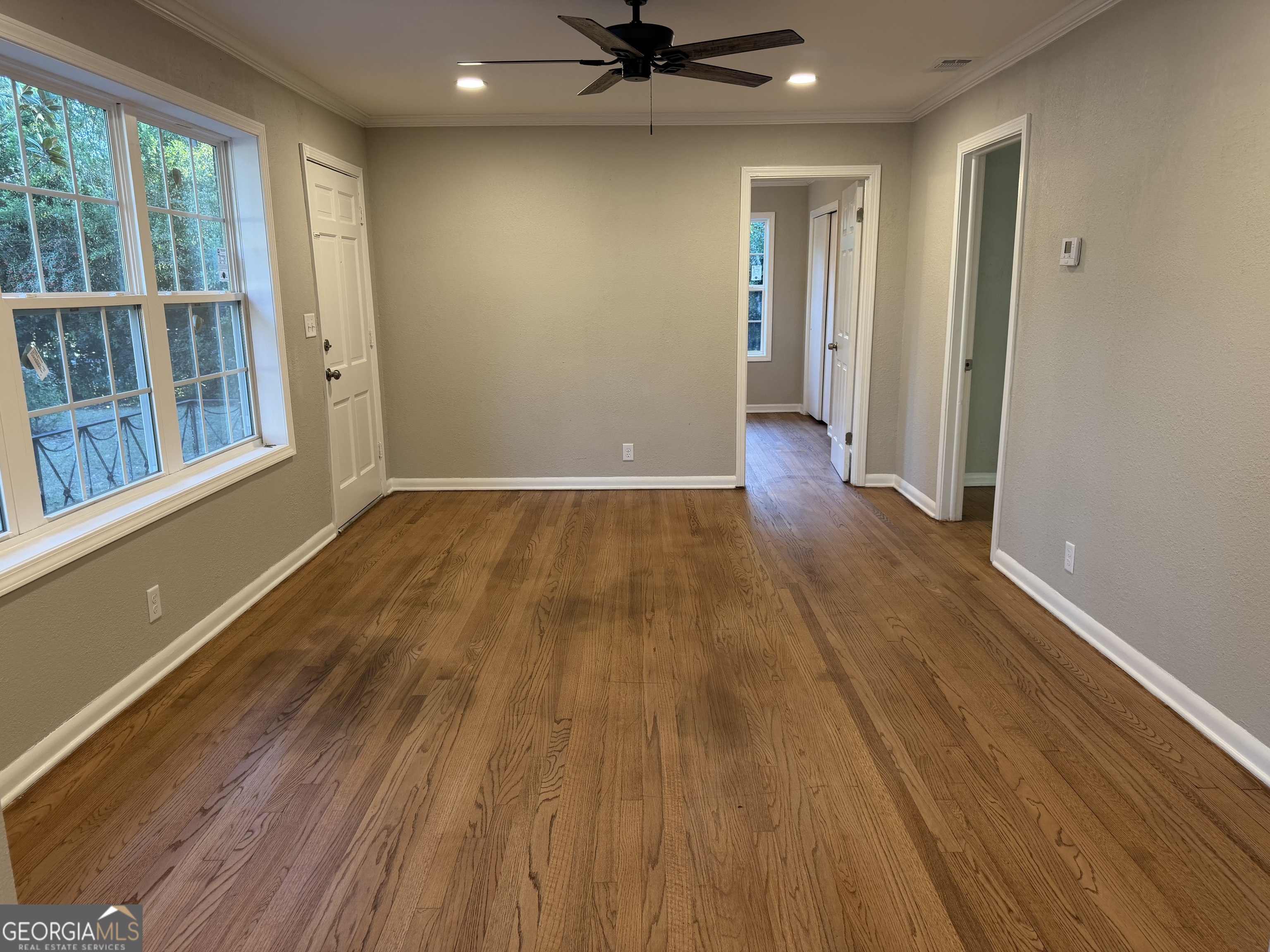 116 Country Club Road Dublin, GA 31021 - Photo 14 of 22 wooden floor in an empty room with a window