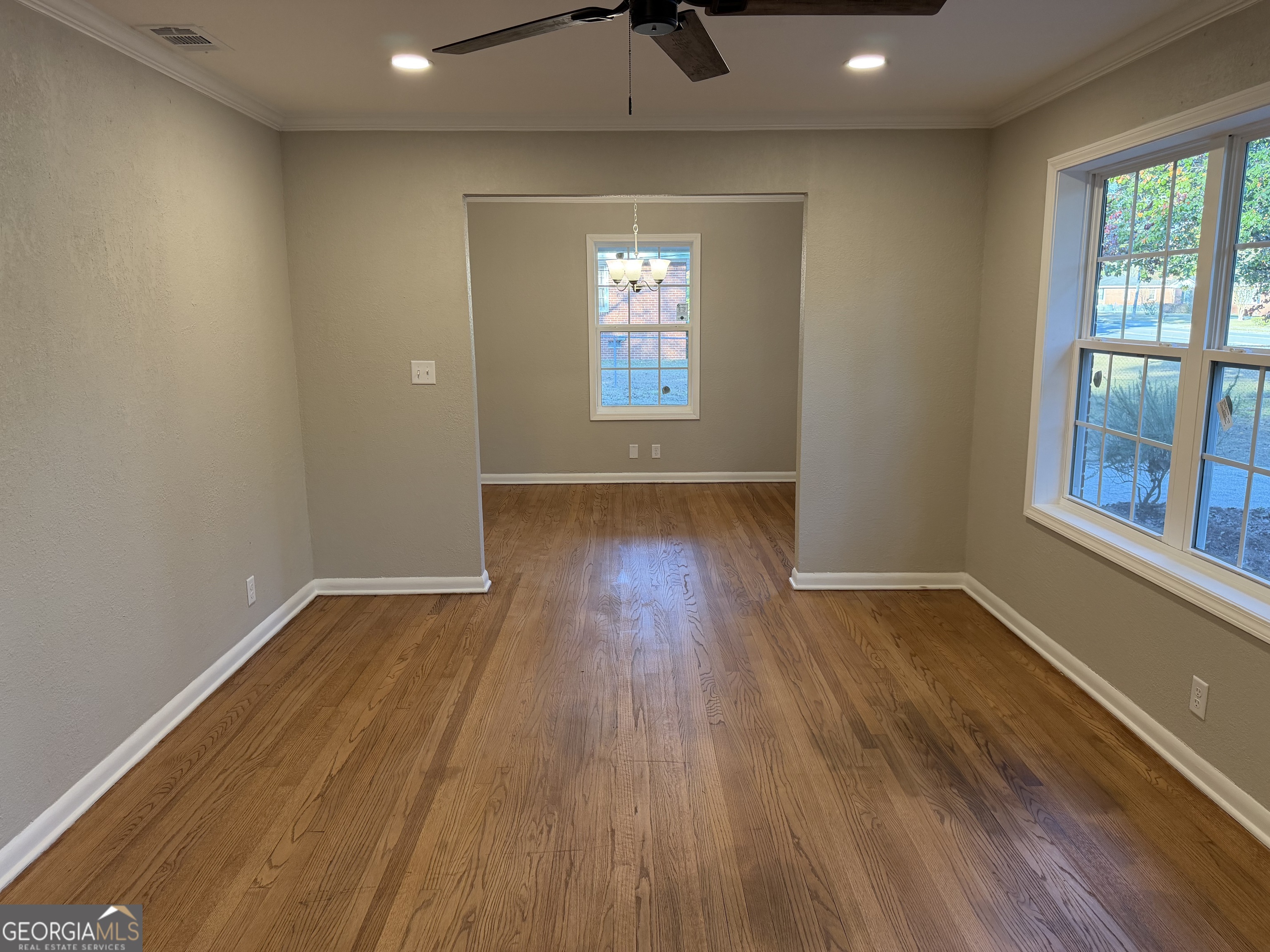 116 Country Club Road Dublin, GA 31021 - Photo 15 of 22 an empty room with wooden floor and windows