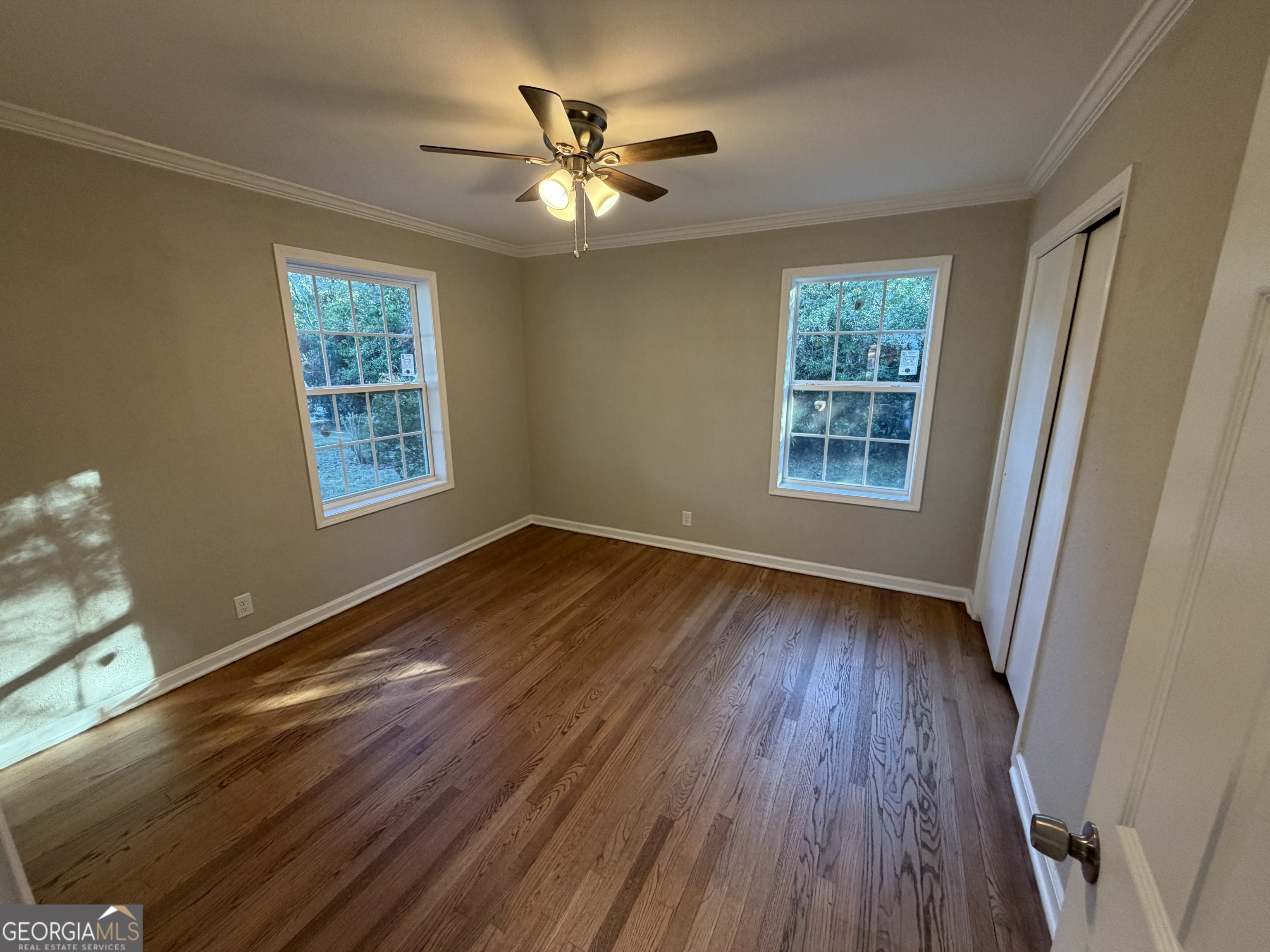 116 Country Club Road Dublin, GA 31021 - Photo 16 of 22 a view of an empty room with wooden floor and a window