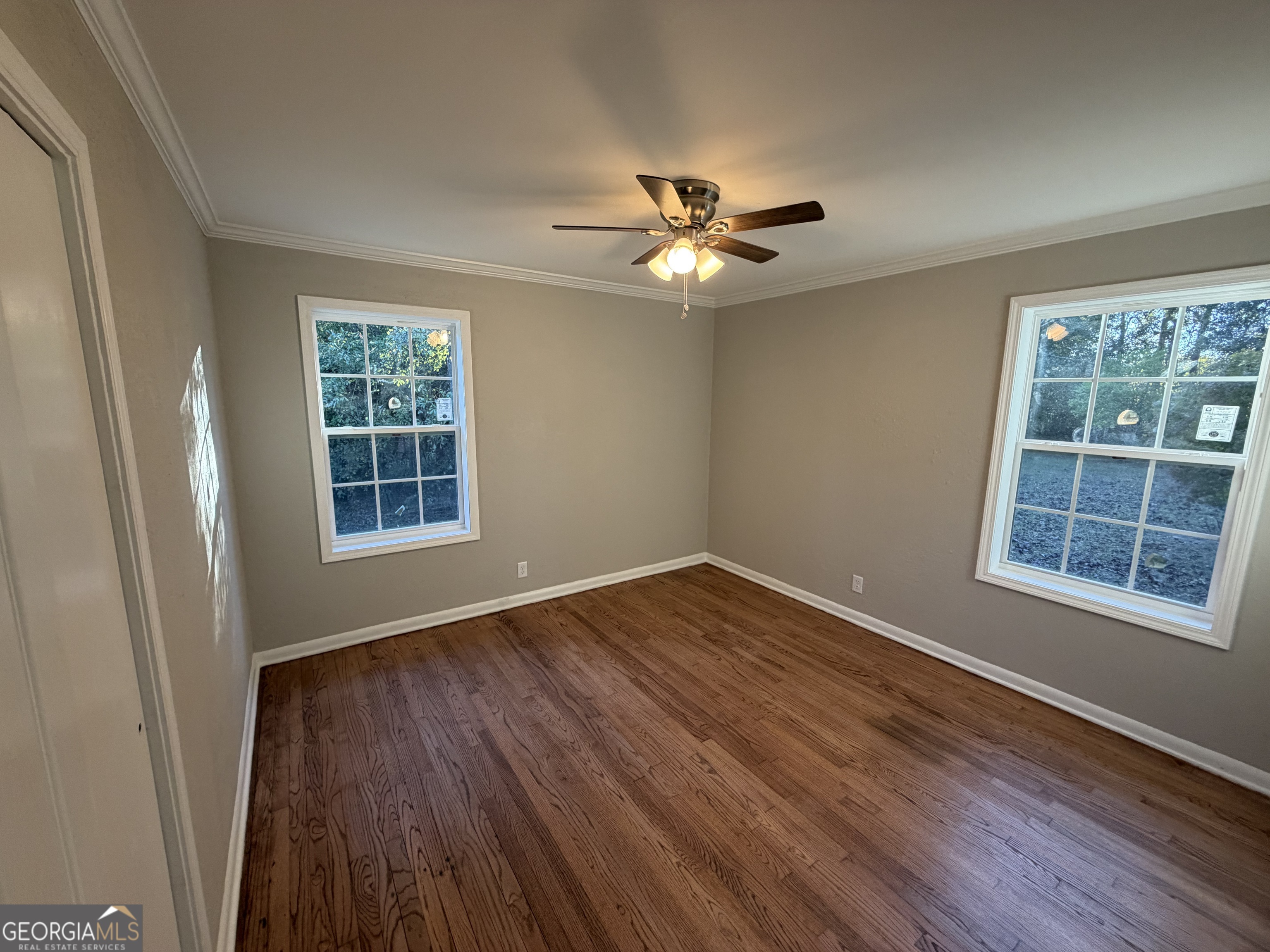 116 Country Club Road Dublin, GA 31021 - Photo 18 of 22 a view of empty room with wooden floor and fan