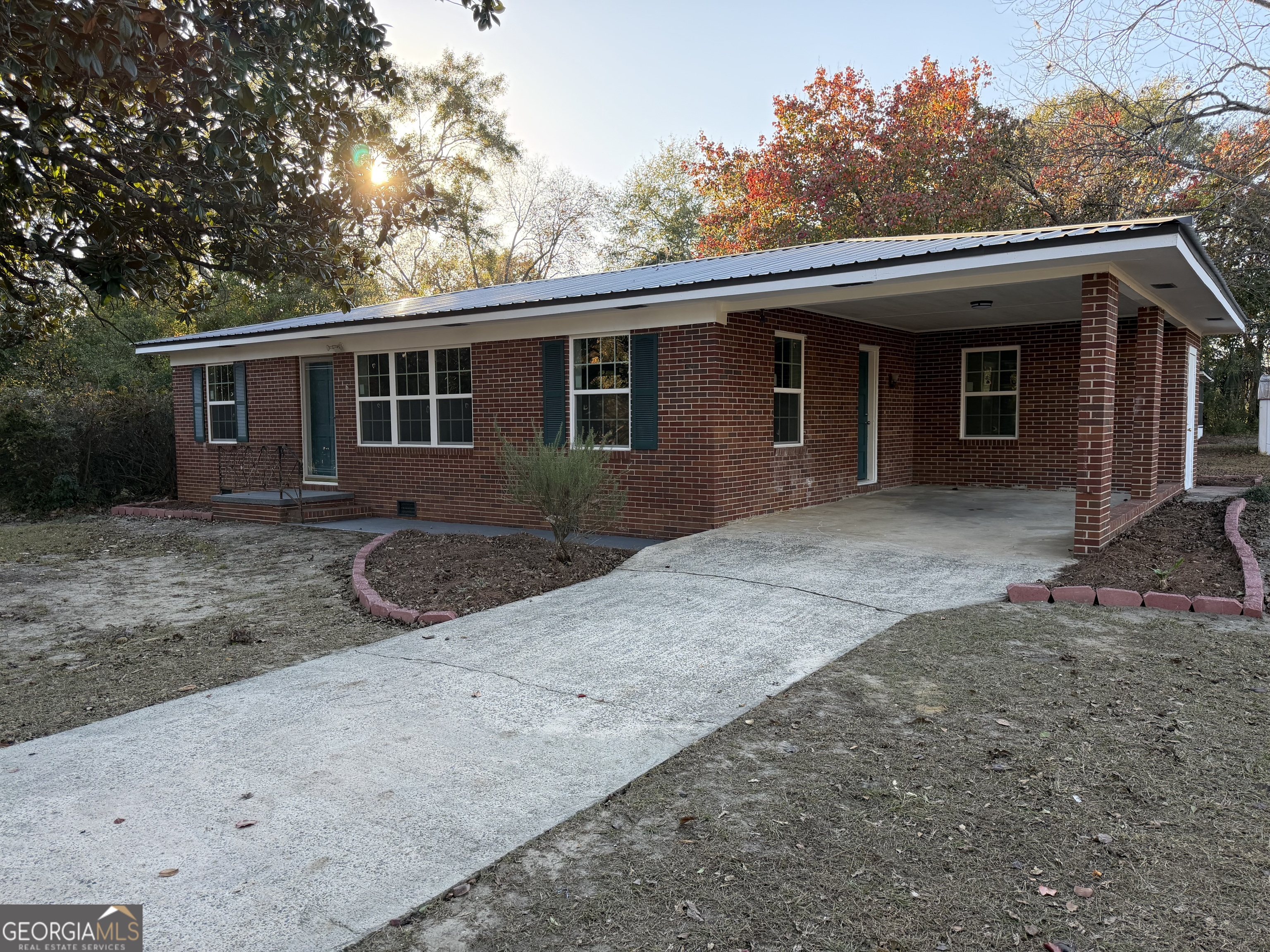 116 Country Club Road Dublin, GA 31021 - Photo 2 of 22 a front view of house with yard and trees in the background
