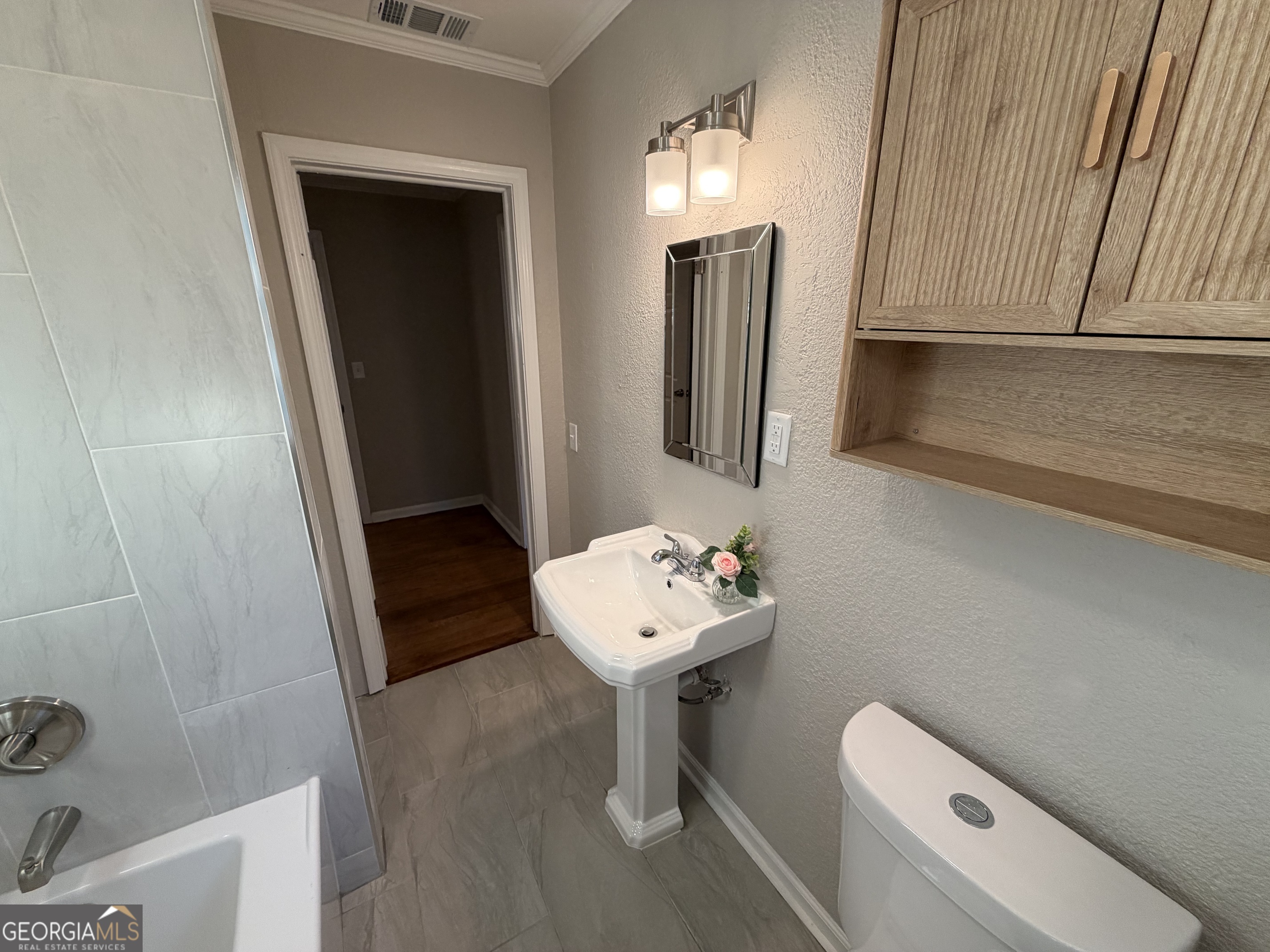 116 Country Club Road Dublin, GA 31021 - Photo 21 of 22 a bathroom with a sink toilet and a mirror