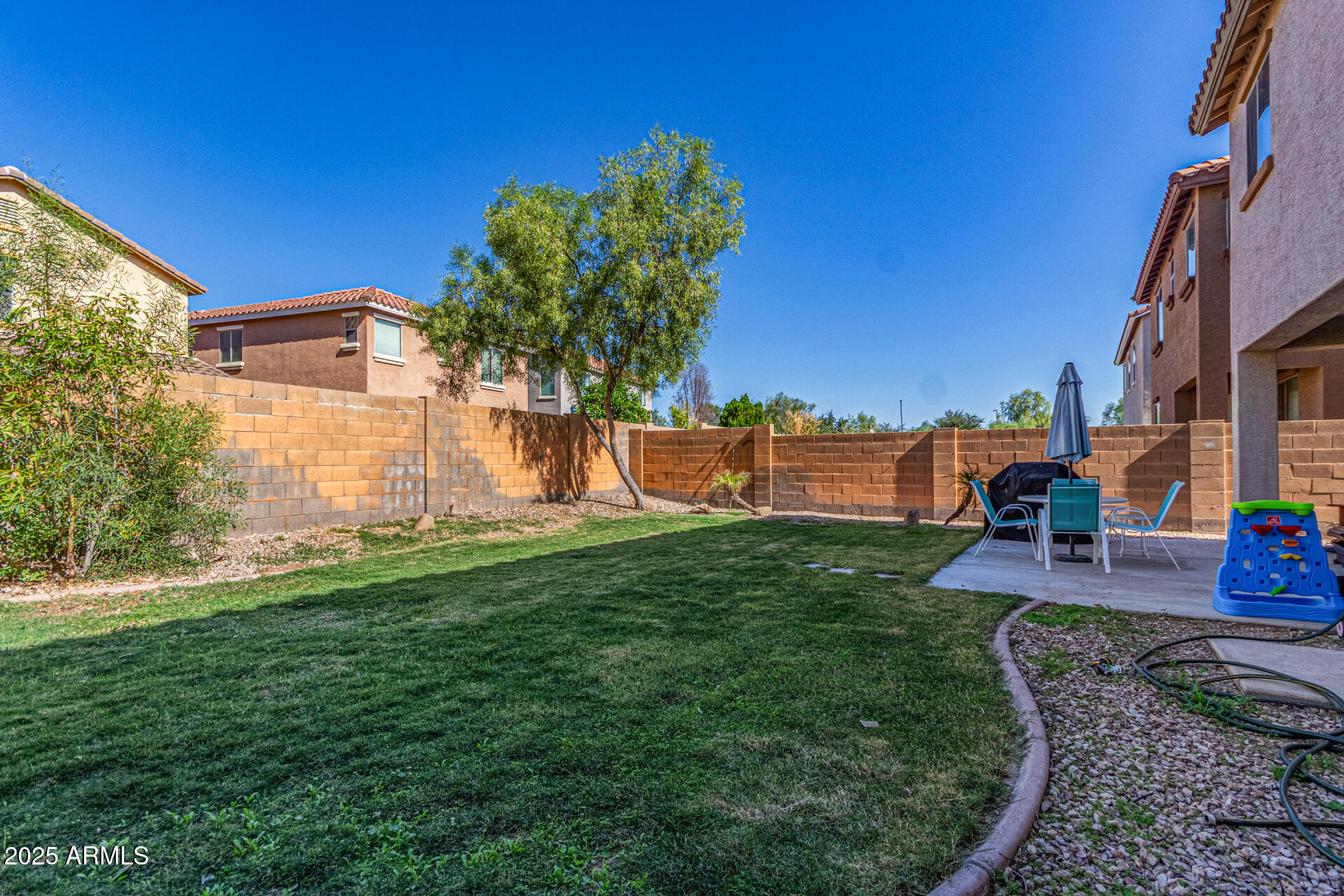 3802 East Chickadee Road Gilbert, AZ 85297 - Photo 28 of 29 a view of a patio with a table and chairs under an umbrella