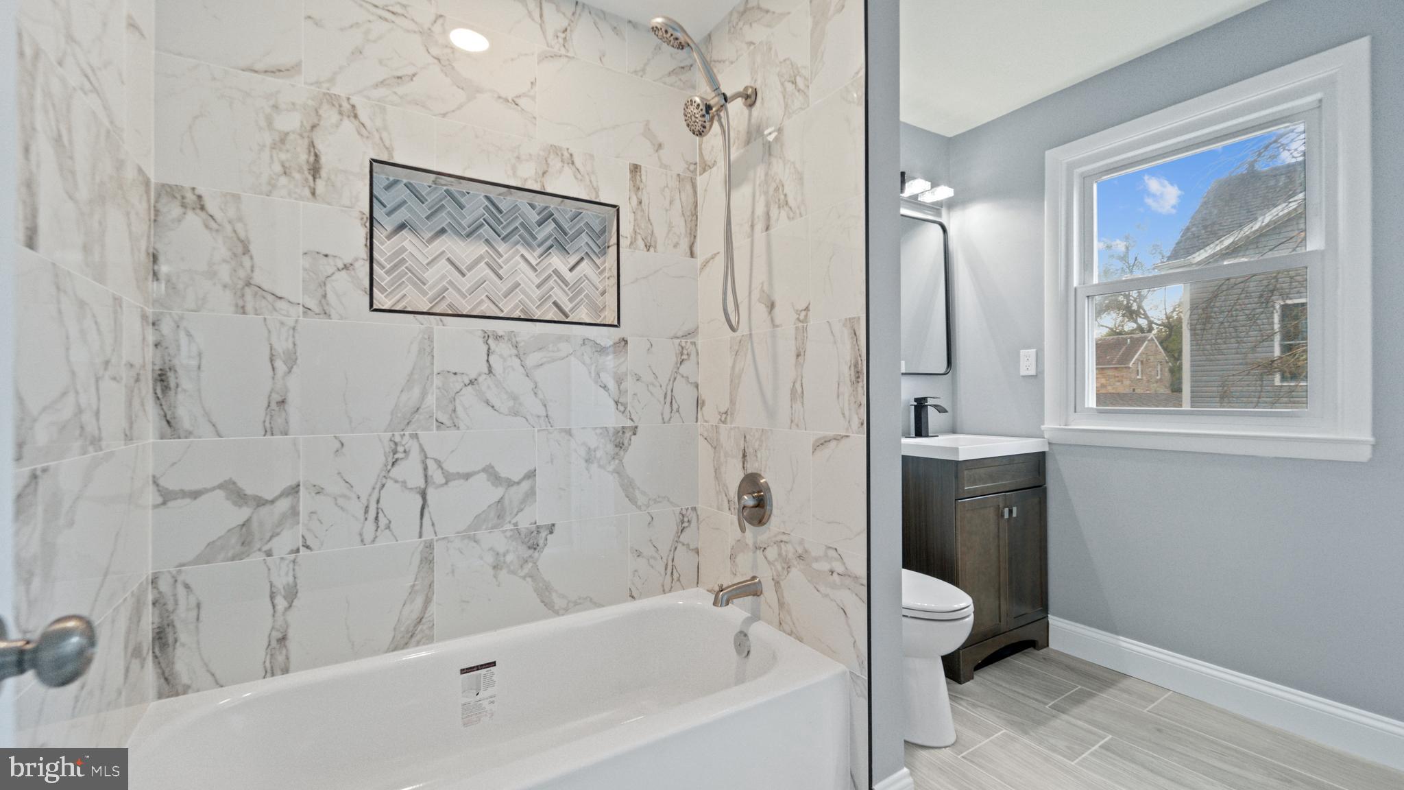3605 Chapman Road Randallstown, MD 21133 - Photo 56 of 65 a bathroom with a bathtub and a shower