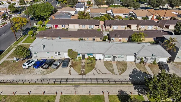 an aerial view of a house with garden space and seating area