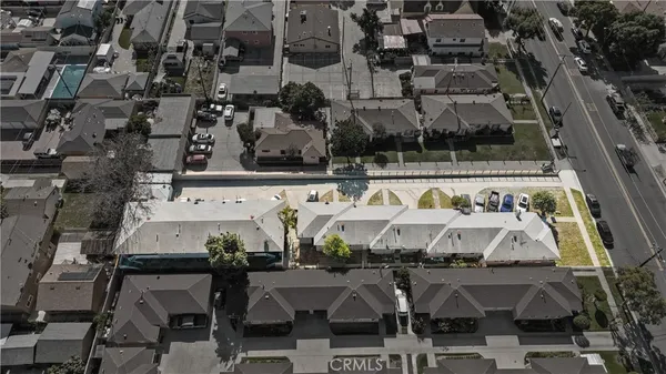 an aerial view of a large building with cars parked