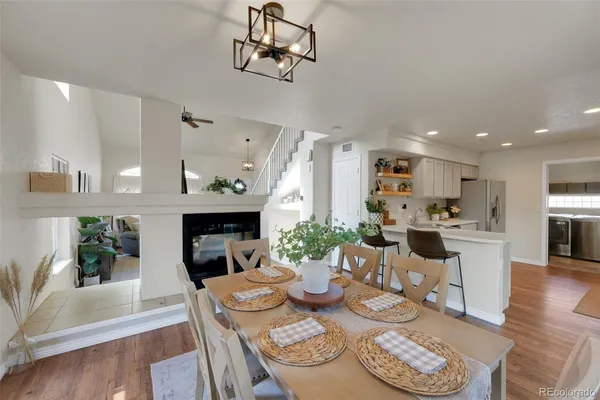 a view of a dining room with furniture a chandelier and wooden floor