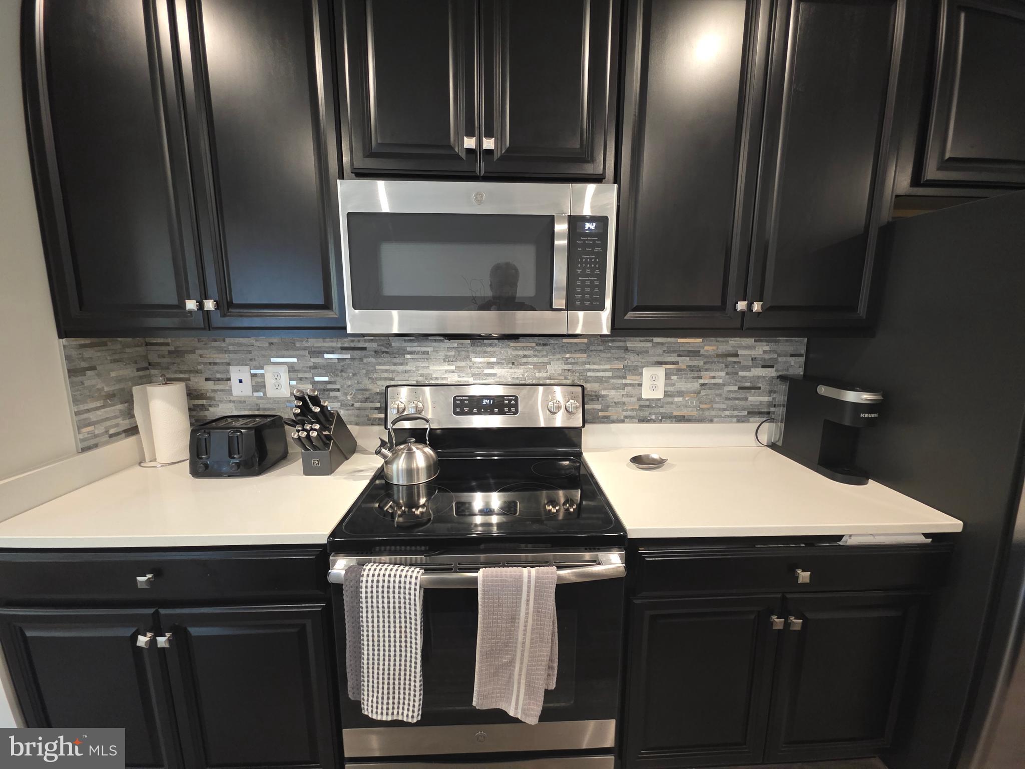 14510 Hunts Farm Road Brandywine, MD 20613 - Photo 26 of 74 a kitchen with a sink stove and cabinets