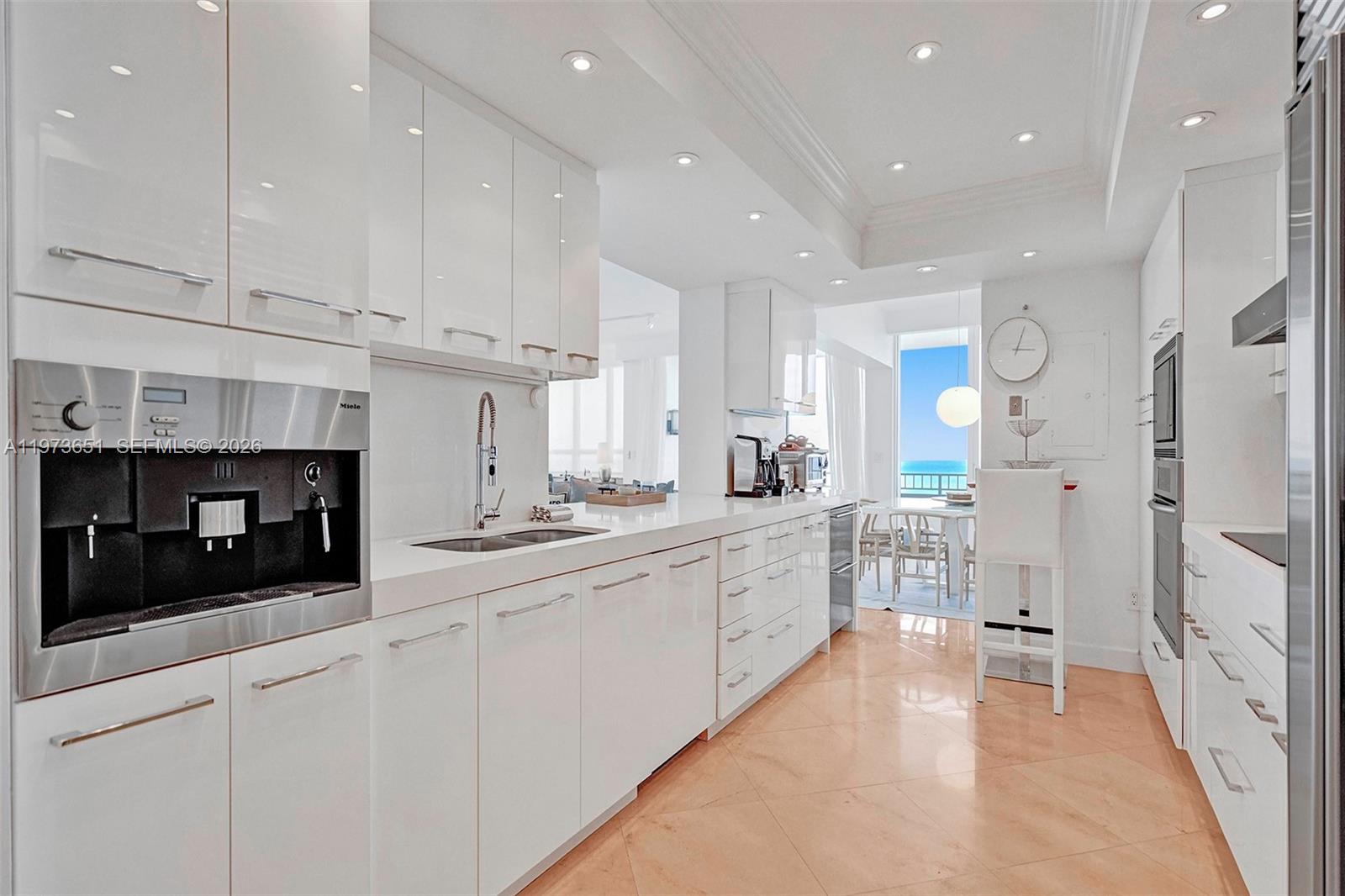 10205 Collins Avenue, Unit P8 Bal Harbour, FL 33154 - Photo 17 of 56 a kitchen with stainless steel appliances white cabinets and a refrigerator