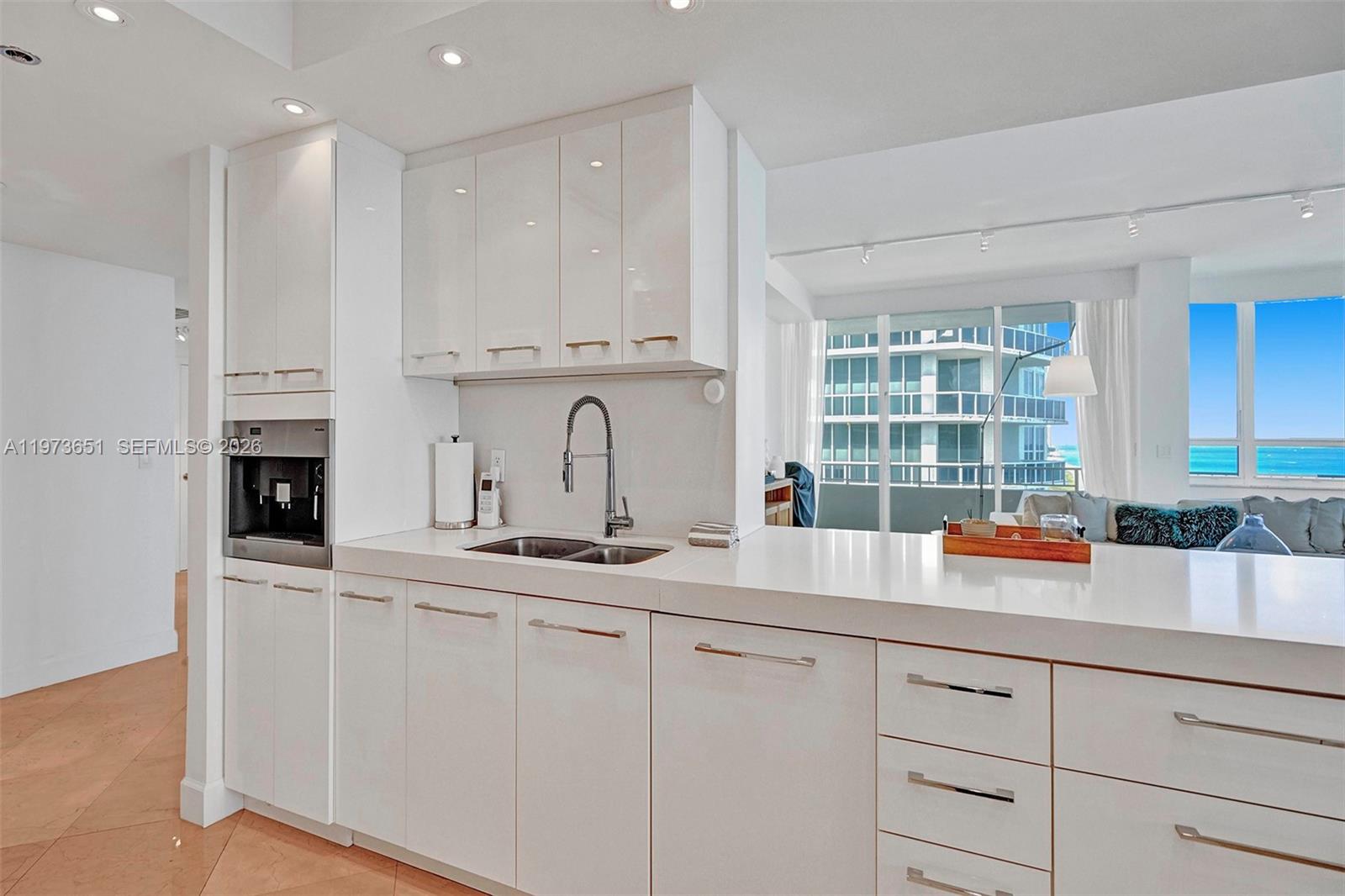 10205 Collins Avenue, Unit P8 Bal Harbour, FL 33154 - Photo 22 of 56 a kitchen with stainless steel appliances granite countertop white cabinets and window