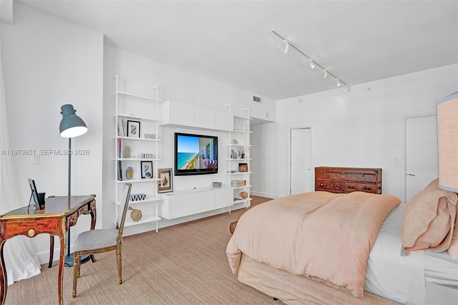 10205 Collins Avenue, Unit P8 Bal Harbour, FL 33154 - Photo 36 of 56 a bedroom with furniture and a flat screen tv