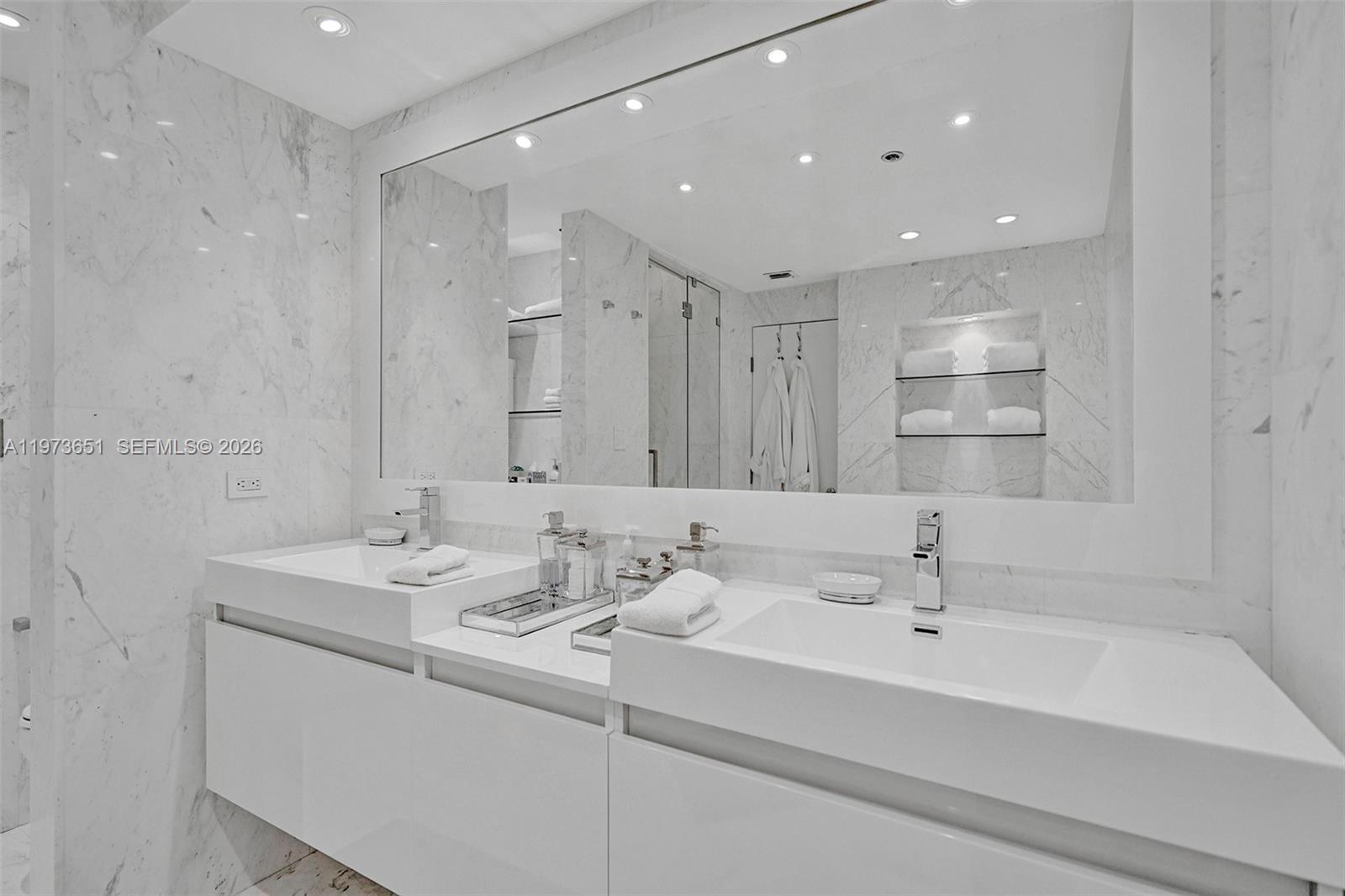 10205 Collins Avenue, Unit P8 Bal Harbour, FL 33154 - Photo 41 of 56 a bathroom with a sink and a mirror