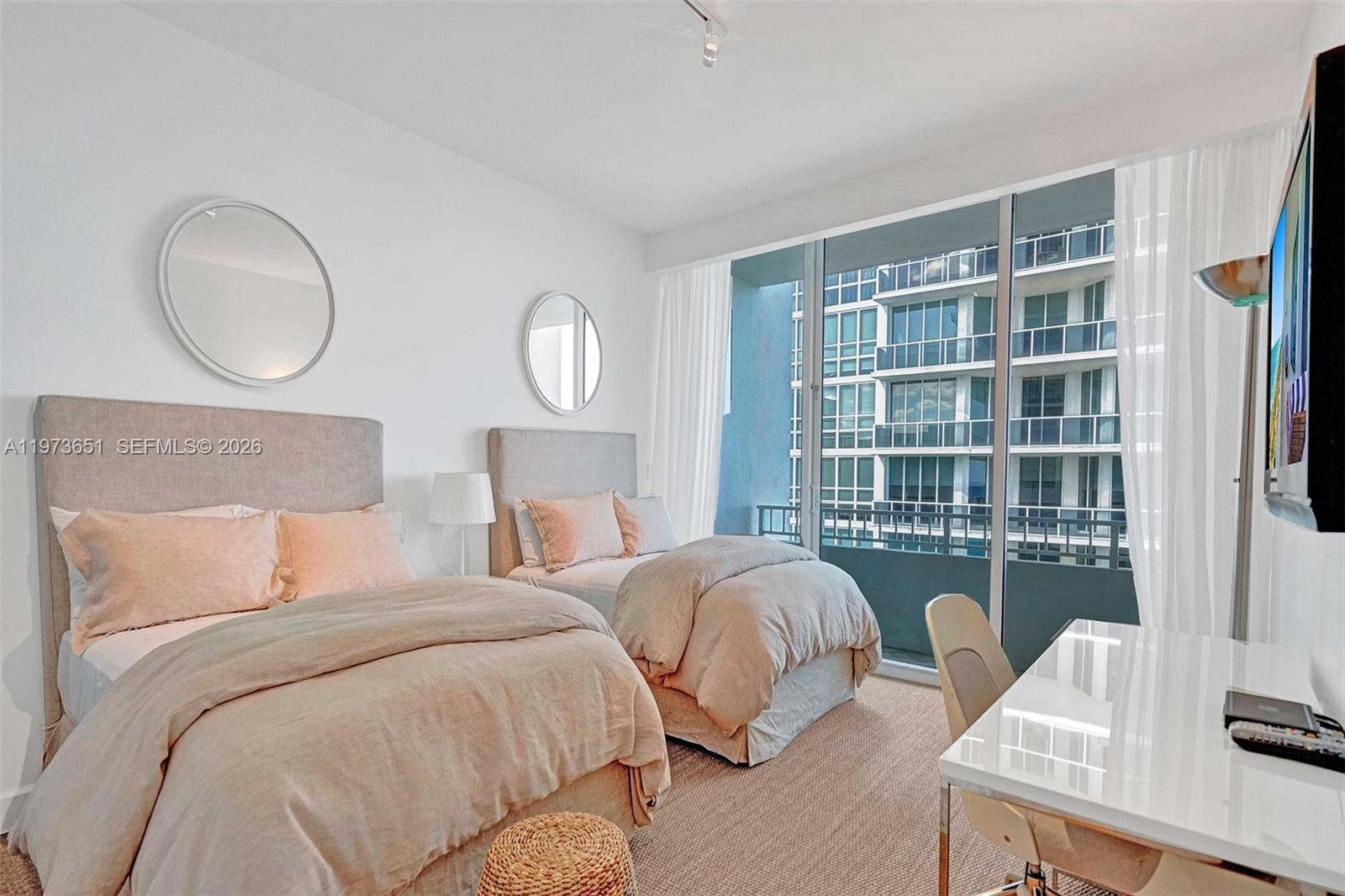 10205 Collins Avenue, Unit P8 Bal Harbour, FL 33154 - Photo 45 of 56 a bed room with two bed and a window
